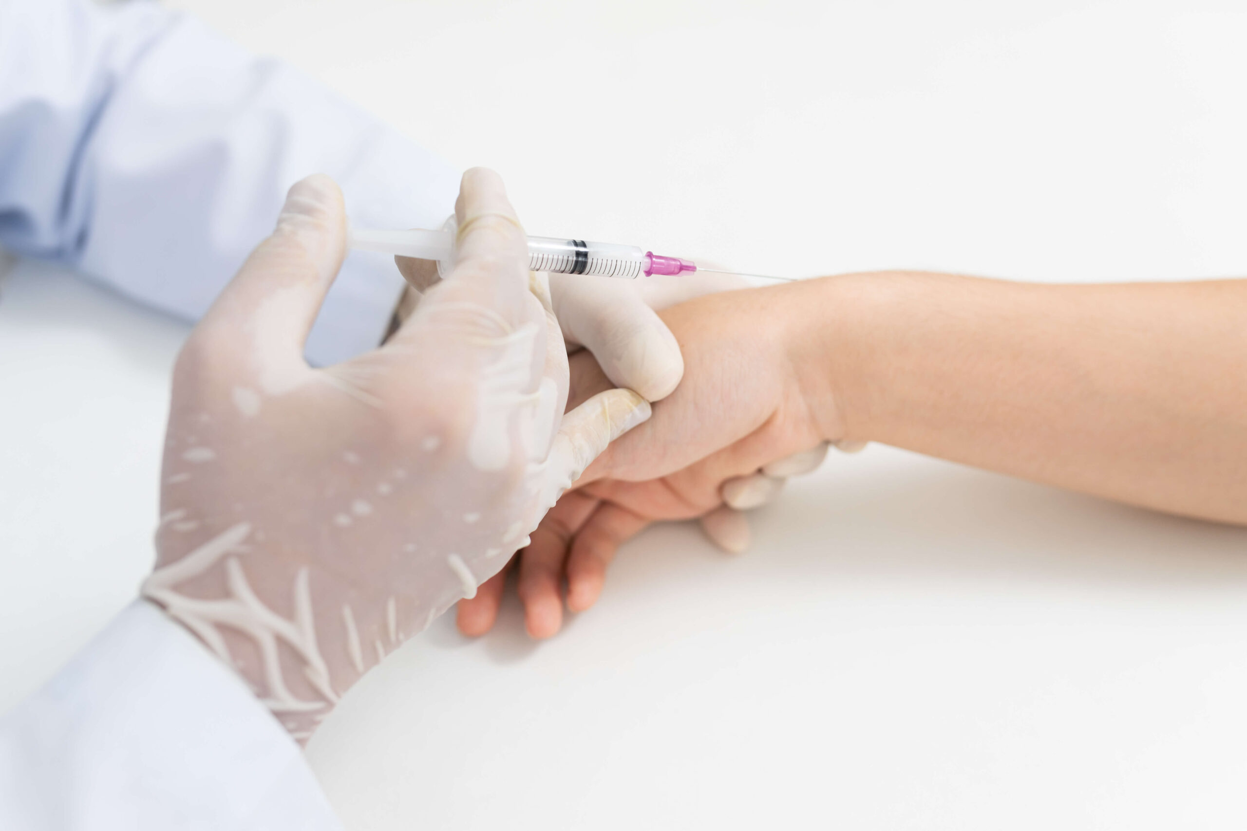 Healthcare professional administering a medical shot to a patient's arm