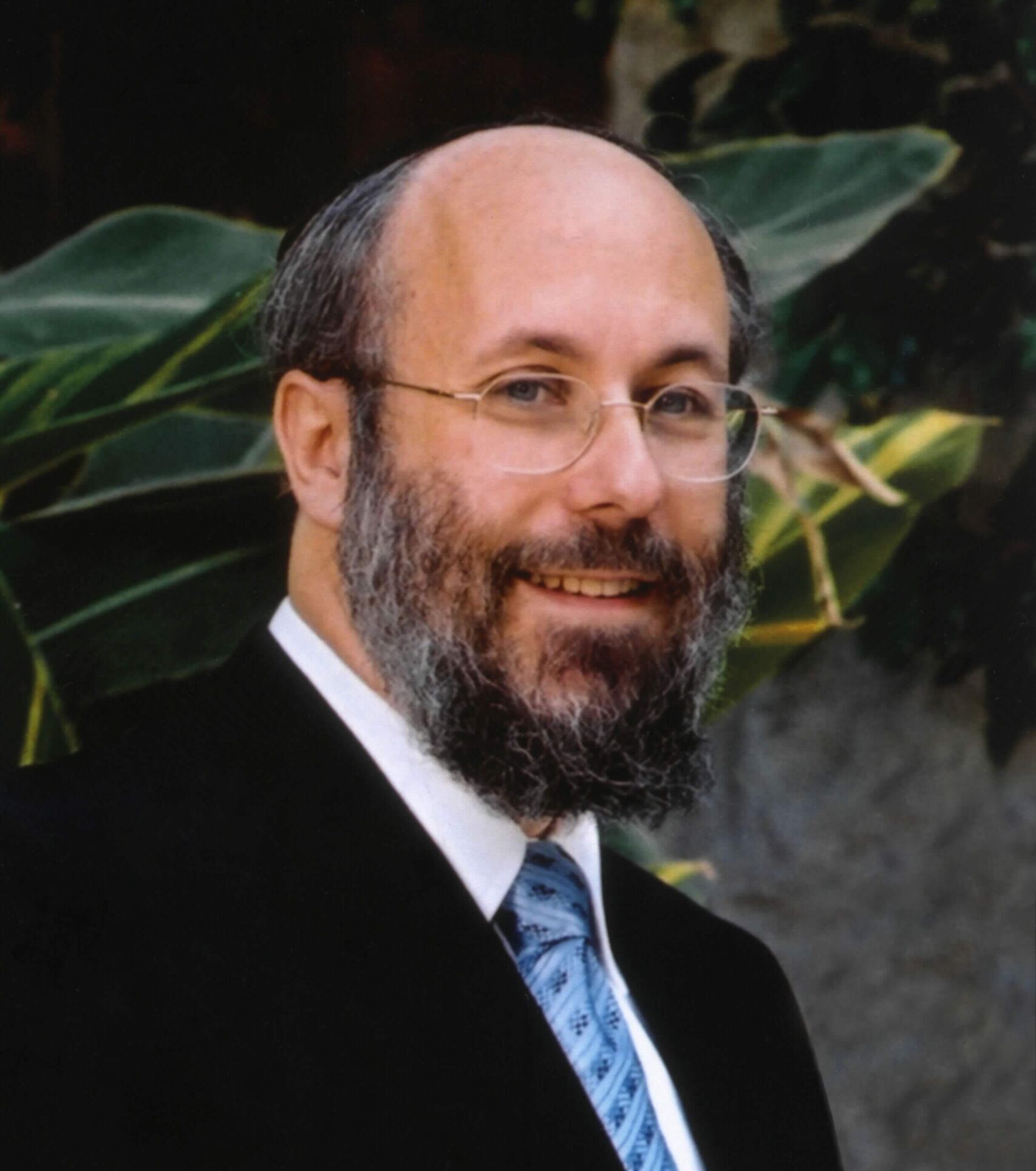 Portrait of the founder of Terem - a man with a beard and glasses smiling